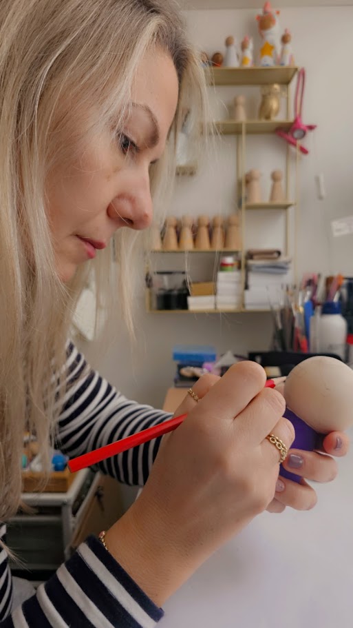 Betül painting a peg doll